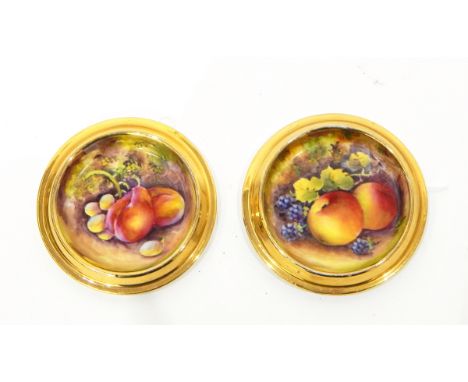 Pair of Royal Worcester porcelain coasters with circular stepped gilt rim, central handpainted fruit design, signed underneat