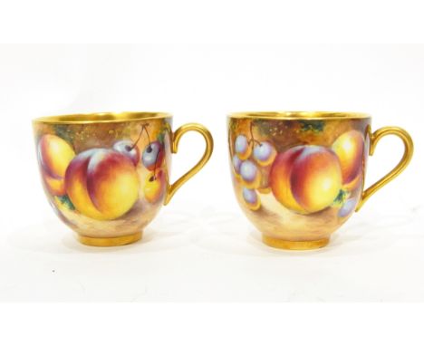 Two 20th century Royal Worcester miniature coffee cups and saucers, gilt interiors, handles and rims, fruit decorated with pe