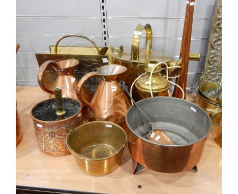 Large brass watering can, an embossed metal magazine rack, two large copper ewers, a brass paraffin lamp lacking shade, a ver