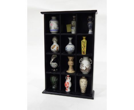 Black collectors shelf unit and contents of 12 modern Japanese miniature porcelain vases and a pair of Oriental prints with c