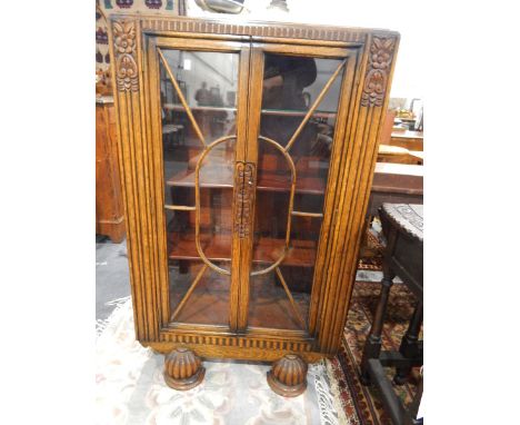 Oak glazed bookcase with pair panel doors enclosing shelves, with floral carved decoration, width 75cm together with an oak c