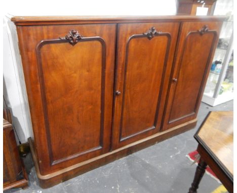 Victorian mahogany linen cupboard, the three panel doors enclosing sliding trays, raised on a plinth base, length 181cm 