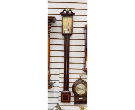 18th century mahogany stick barometer with broken swan neck pediment, central brass finial, over glazed front brass graduated