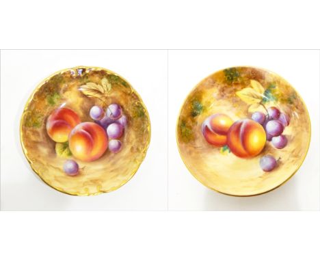 Two 20th century Royal Worcester pin trays of circular form, fruit decorated, signed indistinctly, 11cm and 10cm diameter 