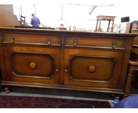 Oak side cupboard with two frieze drawers, pair panel doors below enclosing shelf, on turned feet, width 137cm 