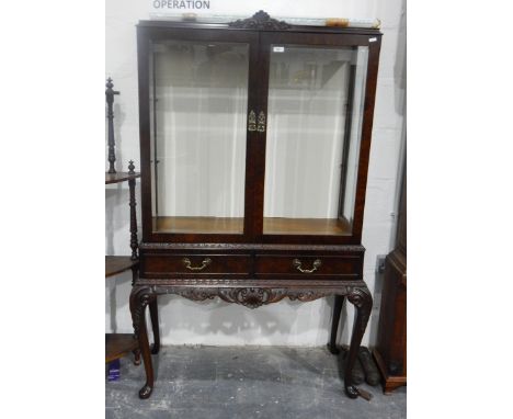 Chippendale-style mahogany display cabinet with glazed sides and panel doors, enclosing glass shelves, pair of frieze drawers