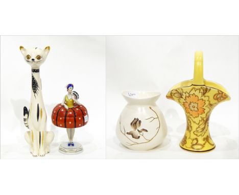 Porcelain lidded pot in the form of a 1920's dancer, a pottery model of a cat, a Tuscan Decoro pottery basket and a Carltonwa