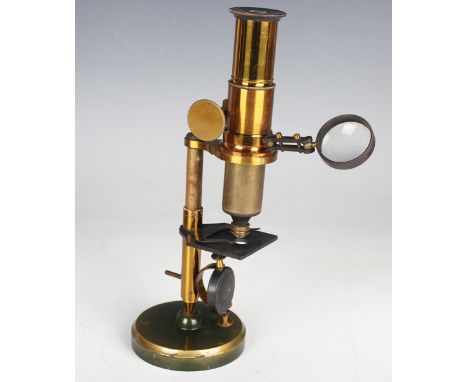 A late 19th century lacquered brass monocular microscope with rack and pinion focusing, condenser and mirror, on a ball and s