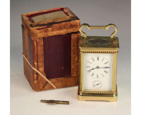 An early 20th century French lacquered brass cased carriage alarm clock with eight day movement striking on a bell, the ename