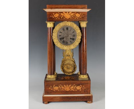 A late 19th century French rosewood portico mantel clock with eight day movement striking hours and half hours on a bell via 