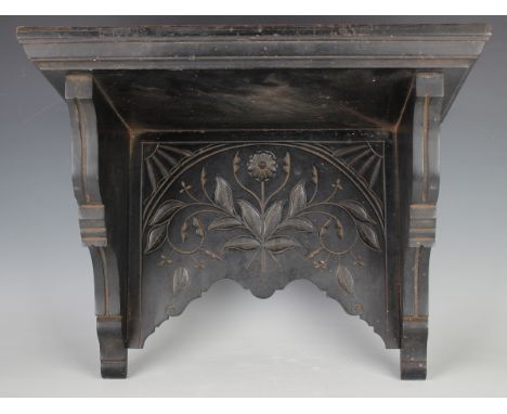 A late Victorian Aesthetic movement ebonized oak wall bracket, width 46cm, together with five other clock wall brackets.Buyer