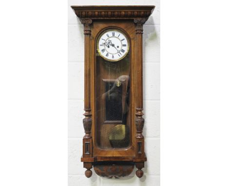 A late 19th century walnut Vienna style wall timepiece with eight day movement striking on a gong, the two piece enamel dial 