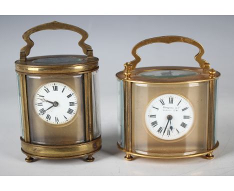 A 20th century French lacquered brass oval cased carriage timepiece with eight day movement, the enamel circular dial with Ro