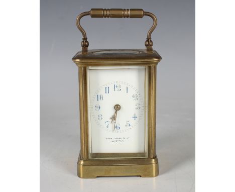 An early 20th century brass carriage clock with eight day movement striking hours and half hours on a gong, the enamelled dia