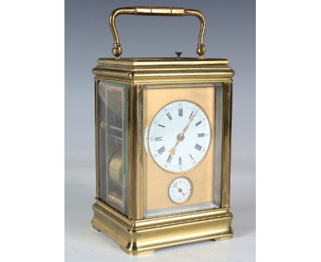 A mid to late 19th century lacquered brass grande sonnerie carriage alarm clock with eight day movement striking and repeatin