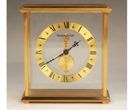 A Jaeger-LeCoultre gilt brass mantel timepiece, the brass chapter ring with black Roman hour numerals surrounding the signed 