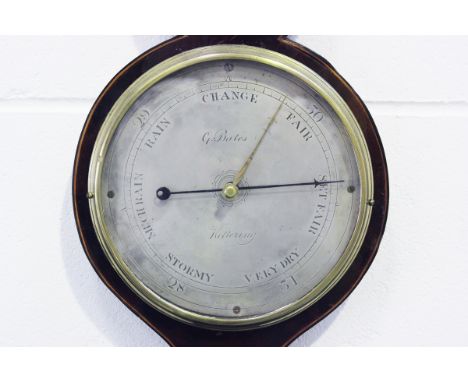 A George III mahogany wheel barometer with alcohol thermometer and silvered dials, inscribed 'G. Bates Kettering', the case w
