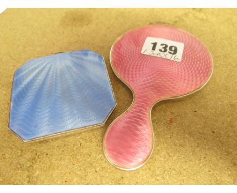A silver and pink enamel hand mirror, together with a blue enamel engine-turned compact