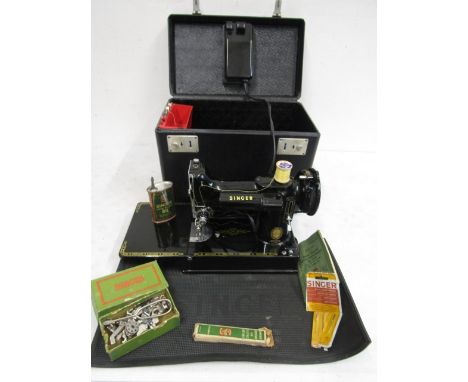 A Singer miniature model 221K sewing machine in its original case with manual, cotton reels, needles, oil can, Singer rubber 