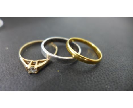 A 22ct gold band ring size I/J - approx weight 1.7 grams - some usage marks - and a 9ct yellow gold dress ring and a silver b