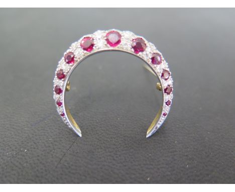 An 18ct yellow and white gold ruby and diamond crescent brooch - Weight approx. 6.9gms - hallmarks  Sheffield 1987 - Width 35