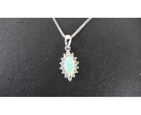 An 18ct white gold pendant - A good quality cabachon cut marquise shaped opal size approx 9mm x 4mm, claw set in white gold a