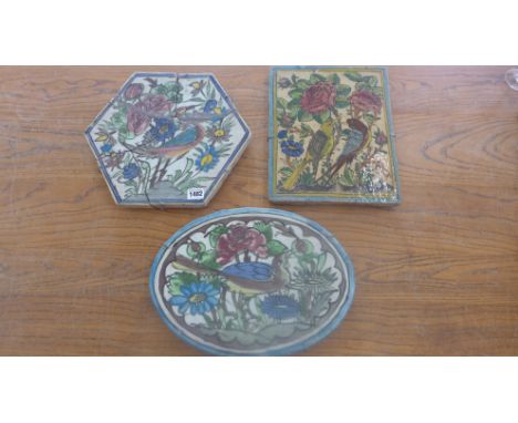 Three Iznik bird decorated stoneware floor tiles largest 31cm x 25cm - hexagonal tile broken and glues, chips and crazing to 