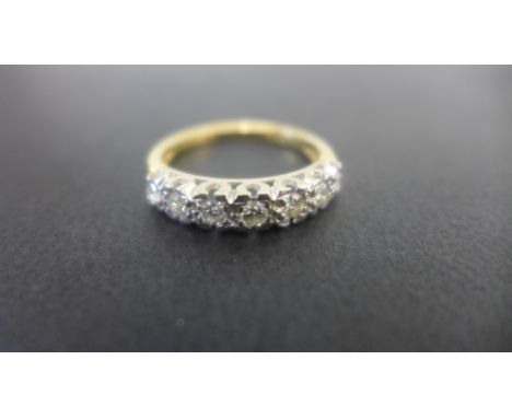 An 18ct gold and diamond ring set with seven stones in white gold setting - ring size P - weight approx 2.8 grams - light wea