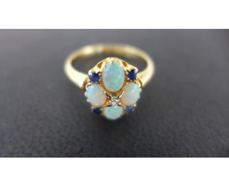 An 18ct gold yellow opal sapphire and diamond cluster ring size P - total weight approx 3.5 grams - in good clean condition