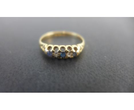 An 18ct gold diamond and sapphire five stone ring set with three cornflower blue sapphires and two diamonds - ring size L - w