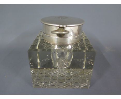 A rare silver top desk inkwell with a lift up watch fitting holding a top wind 8 day oversize pocket watch hallmarked London 