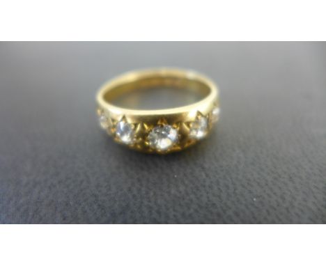 An 18ct gold diamond set Gypsy style ring set with five old European cut stones the largest being approx 0.35ct, the smallest