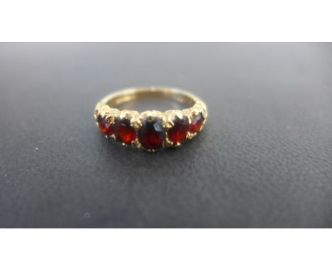 A 9ct gold Victorian style garnet ring set with five oval cut garnets - full modern hallmarks - ring size O - weight approx 3