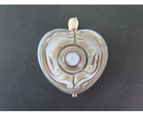 A wall carved jade heart pendant with a gold metal mount - 5cm x 4cm - good overall condition