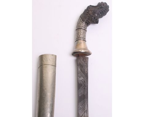 An Indonesian Parang, slightly curved single edge blade 60cms with black and silver coloured etched pamor, horn pommel carved