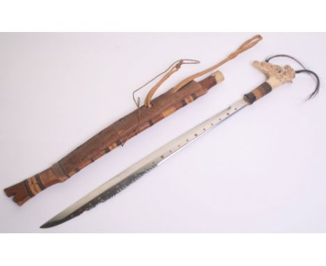 Borneo Head Hunters Sword Mandau, 20th century, polished blade inlaid with copper and brass stars and discs, bone hilt carved