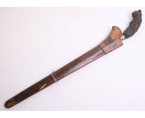 A Balinese Dagger, straight single edge blade 25cms, horn hilt with demonic head pommel also carved with assorted animals, in