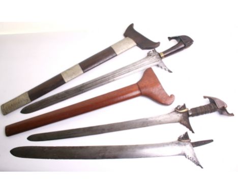 A Moro Kris, straight blade 54cms, cord bound grip, wooden pommel and later scabbard; another with 54cms blade having pattern