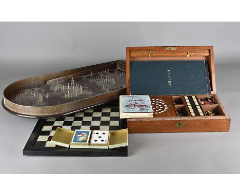 A games lot, including a mahogany cased compendium with contents, a mother or pearl and ebony chess board, bagatelle board et
