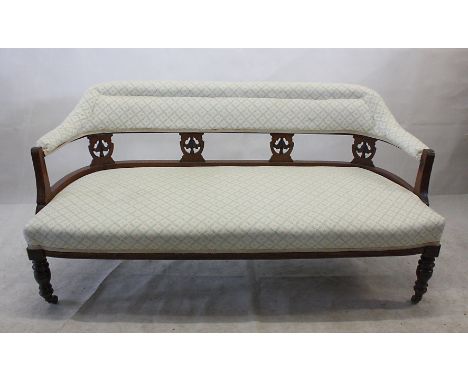 A Victorian two seater sofa, having mahogany frame, pierced back splats, with later cream floral upholstery, 140 cm wide 