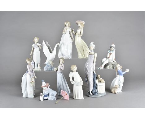 A collection of Lladro and Nao porcelain figures, to include a boxed figure of a clown and his partner both with puppies, a L
