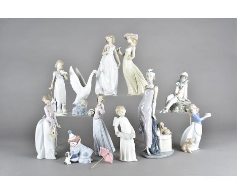 A collection of Lladro and Nao porcelain figures, to include a boxed figure of a clown and his partner both with puppies, a L