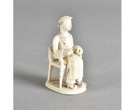 A 19th century Chinese ivory figure of a seated gentleman, wearing long robes and beads, 5.5 cm highCracks and restoration to