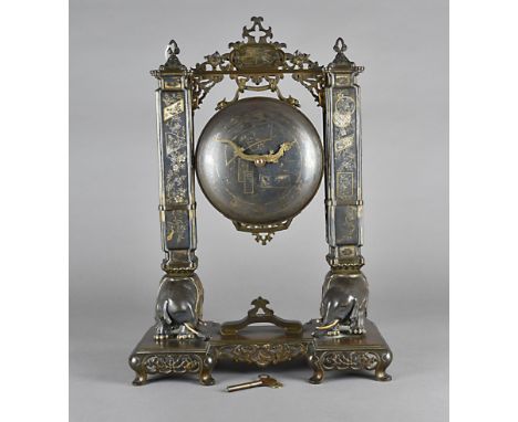 A Japanese Meiji period bronzed spelter mantel clock, modelled as a gong and bracket supported on elephant bases and scroll p