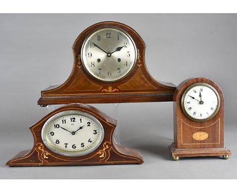 An Edwardian mahogany domed inlaid mantle clock, together with an inlaid example, both with 30 hour drum  movements and anoth