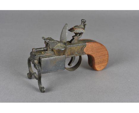 A Vintage Dunhill Tinder Pistol lighter, using the handle and hammer of a flintlock pistol, the trigger setting of lighter me