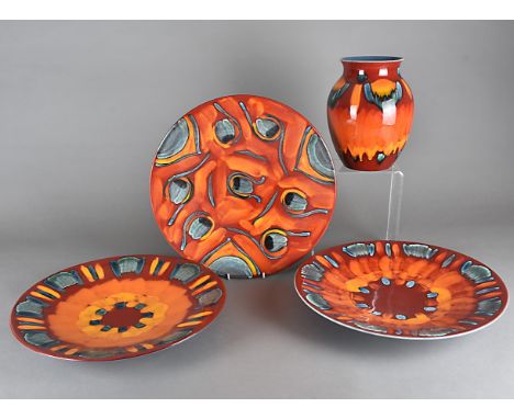 Four large items of modern Poole pottery,  including three large platters, and a ovoid vase, all in orange, blue and red, pla