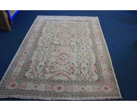 A large woollen Pakistan carpet, Zeliger style in cream green and red, 270 cm x 189cm  