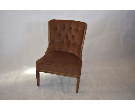 A reproduction button-back nursing chair, tan fabric, tapered supports, 36cm high x 66cm wide x 58cm deep 