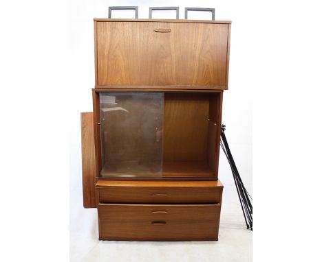 A 1960s ladder rack shelving unit, comprising three black supports, a bureau unit, a glazed display and three drawer unit, fo